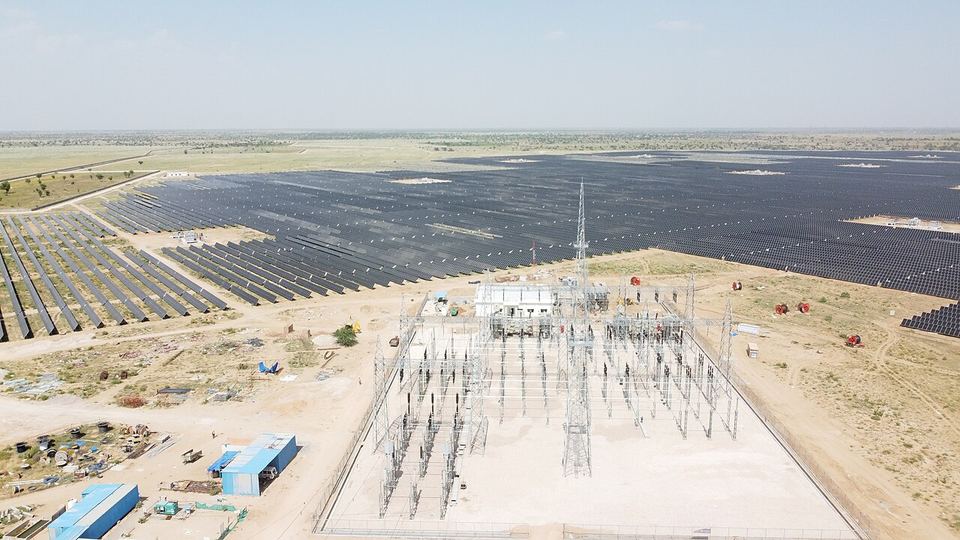 Aerial view of a large solar power plant and its substation