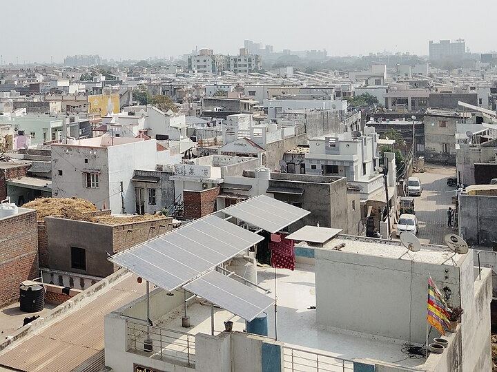 Solar panels on the rooftops of houses in an Indian city